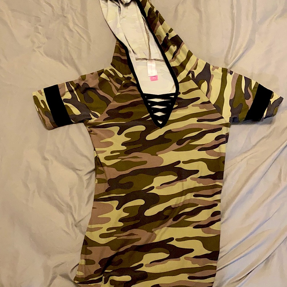 It is a camo shirt. It is low cut. It is a hoodie shirt. It is a polyester shirt